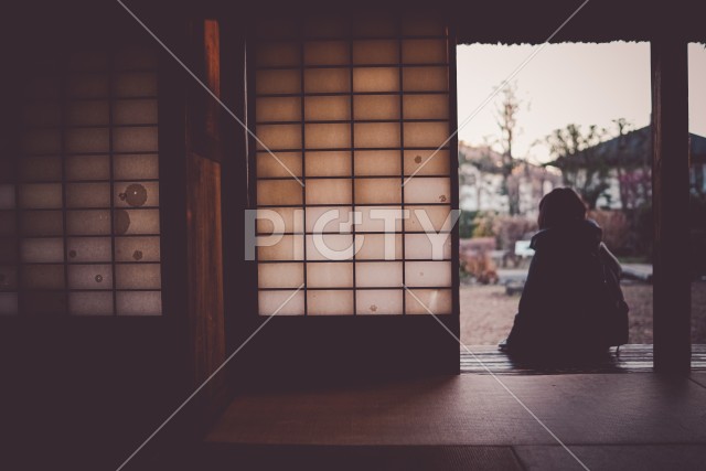 日本家屋の縁側に座る女性