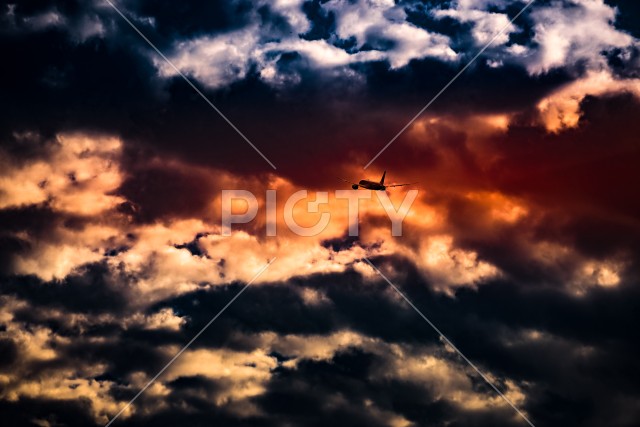 飛行機のシルエットと夕暮れの空