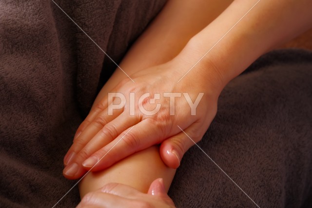 腕のオイルマッサージを受ける女性